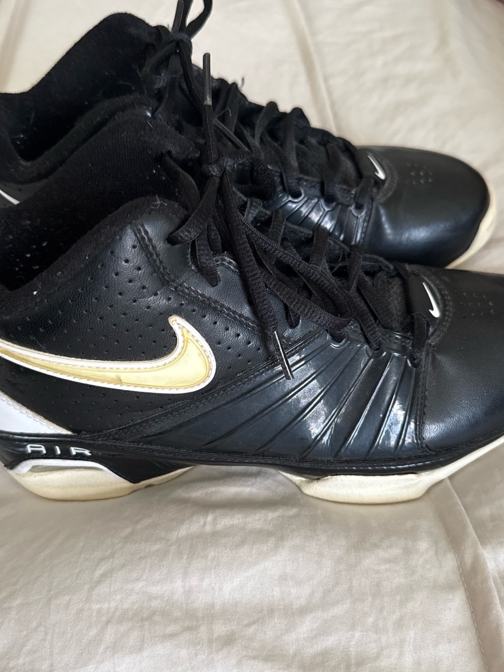 Nike Black Leather Sneakers with Gold Swoosh Accent